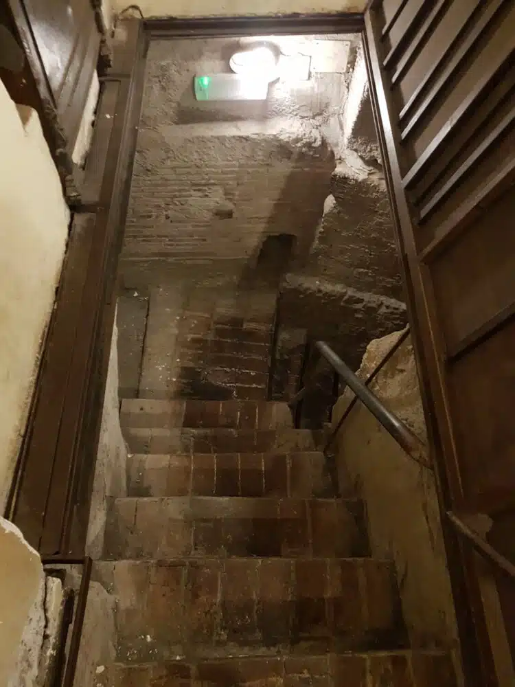l'accès aux vestiges du théâtre depuis la cave de l'un des immeubles avoisinants (Naples)